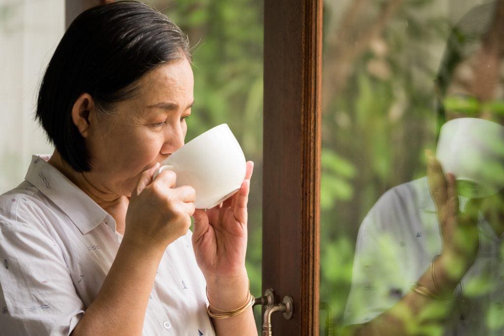 elderly asian woman enjoy sipping tea, diabetes free because she had taken genetic tes before